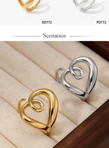 Close-up of heart-shaped hollow twisted rings in gold and silver finishes on a velvet box
