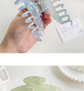 Detailed view of iridescent resin hair claws with hollow design and pearl finish