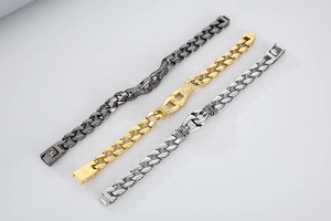 Detailed view of three-tone Cuban chain bracelets in gold, silver, and gunmetal finishes