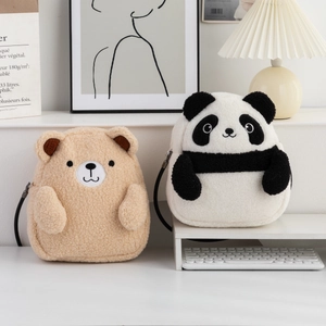 Detailed view of plush bear and panda shoulder bags with soft lamb wool texture