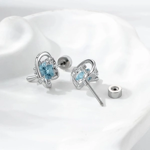 Star-accented silver heart studs with light blue zircon and secure screw-back design