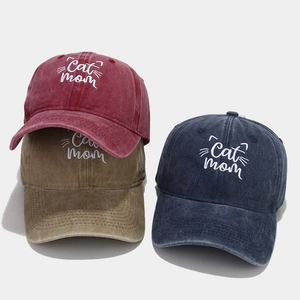 Three washed cotton baseball caps with embroidered Cat Mom text in red khaki and blue