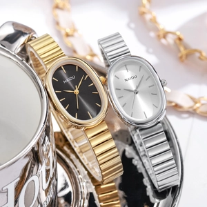 Elegant NAIDU oval quartz watches with gold and silver metal straps on a metallic tray