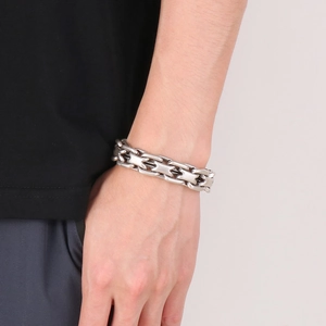Close-up of interlocking stainless steel links on a rugged curb chain bracelet for men