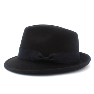 Detail of classic black wool felt fedora hat featuring a matching silk ribbon and bow