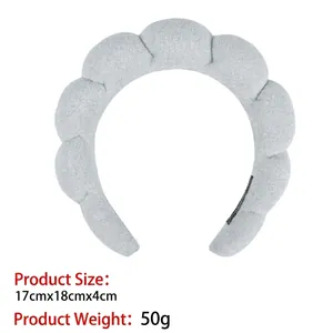 Detailed view of light blue padded sponge headband with cloud texture, 17x18x4cm size