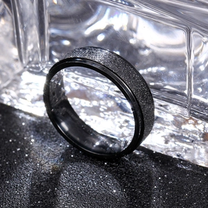 Macro detail of 6mm black matte titanium ring resting on crystalline ice blocks