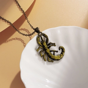 Nordic style bronze alloy scorpion pendant necklace on a white textured plate