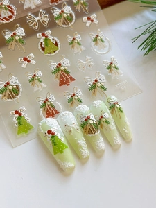 3D embossed Christmas nail stickers featuring festive wreath, bell, and tree motifs