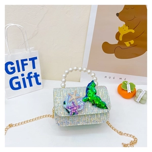 Detail of girls' sequin crossbody bag with pearl handle and mermaid shell decorations