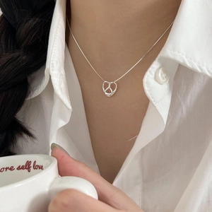 Detailed view of S925 sterling silver heart knot pendant with elegant snake bone chain