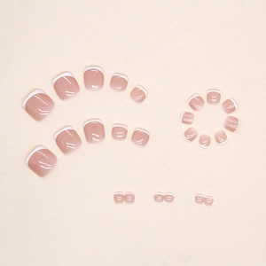 French tip pedicure press-on nails in light pink and white with a glossy resin finish