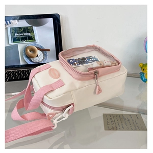Close-up of beige and pink ita bag with a clear PVC window for anime collectibles
