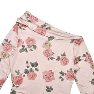 Detail of light pink floral dress featuring a one-shoulder neckline and vintage rose print