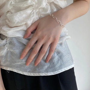 Detail of s925 sterling silver handmade twisted cable chain bracelet on woman wrist