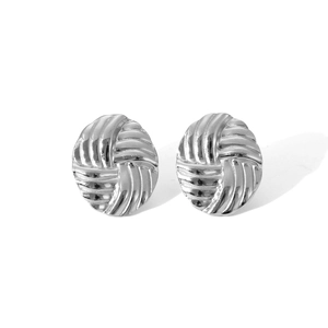 Macro shot of silver woven texture stud earrings with a polished metallic finish