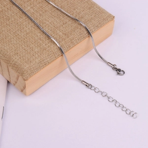 Detail of silver stainless steel snake chain with lobster clasp and adjustable extender