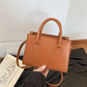 Minimalist caramel brown PU leather square crossbody bag with dual handles and long strap