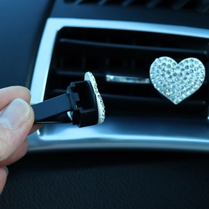 Detail showing the back clip mechanism of a heart rhinestone car air vent accessory