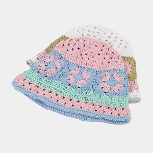 Handmade crochet bucket hats with colorful floral patterns in pastel knit cotton