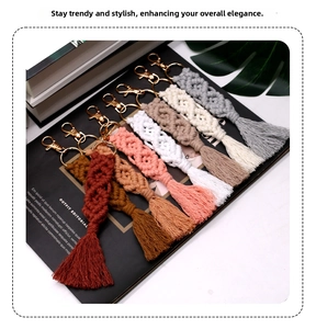 Detail of colorful macramé keychains with tassels and gold lobster clasps on magazine