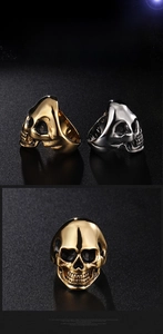 Detail view of gothic stainless steel skull rings in gold and silver with vintage texture