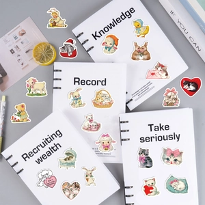 Flat lay of retro pink aesthetic animal stickers on notebooks with cute cat and dog patterns