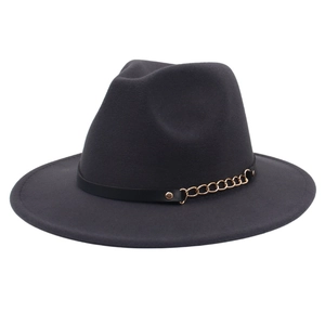 Detail of dark grey fedora hat with black leather band and gold metal chain accent