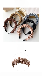 Close-up of pleated satin texture on headband showing the soft silk-like fabric detail