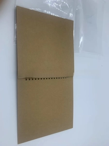 Vertical kraft paper DIY scrapbook photo album with black metal spiral binding in packaging
