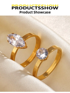 Detail of gold-plated adjustable rings with marquise and round-cut cubic zirconia on silk