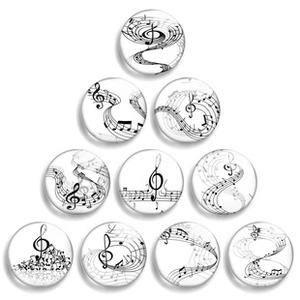 Close-up of luminous glass cabochons with musical treble clef and staff note designs