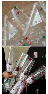 Close-up of snowflake pattern cellophane with colorful pom poms for Christmas gift wrapping