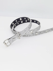 Detail of silver glitter Y2K belt featuring shiny metallic eyelets and sturdy buckle