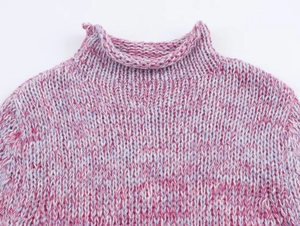Detail of mock neck knit sweater featuring pink and purple variegated gradient yarn