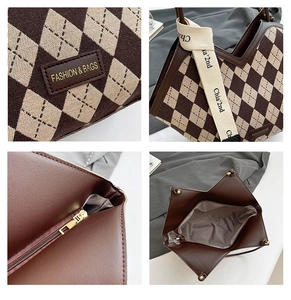 Detail view of large tote bag showing leather tag, shoulder strap and zip closure