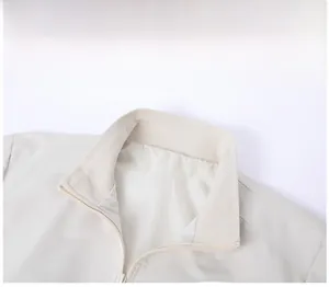 Close-up of minimalist stand-up collar and ribbed inner lining on men's jacket