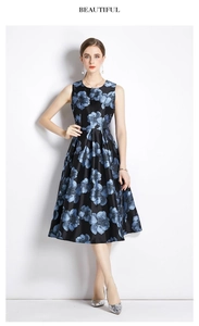 Detail of a black sleeveless A-line floral dress in satin fabric with blue flowers