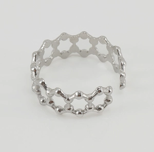 Détail de la sphère alvéolée argentée sur une bague ajustable en acier inoxydable