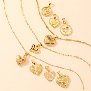 Detailed collection of gold stainless steel heart pendants and textured charms on necklaces