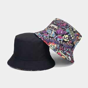 Detail of reversible bucket hat showing classic black side and colorful graffiti print