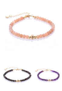 Detailed view of natural stone beaded bracelets with gold-plated accents in three colors