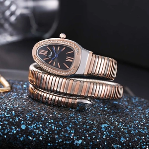 Macro shot of snake-shaped watch with zircon bezel and two-tone coiled bracelet