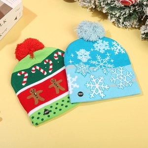 Detail view of knitted Christmas hats with LED ON/OFF button and holiday patterns