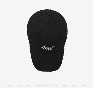 Top view of black faux shearling baseball cap with cream HEART letter embroidery