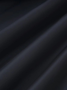 Vue macro détaillée de la texture du tissu en laine noire et de la surface tissée lisse
