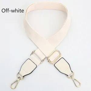 Detail of adjustable off-white canvas strap with gold metal hooks and reinforced stitching