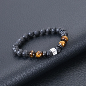 8mm tiger eye and lava stone cross beaded bracelet for men on black leather surface