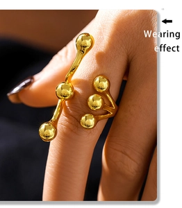 Detail of 18K gold plated titanium steel ring with multiple polished beads on hand