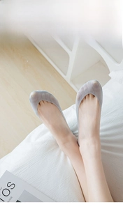 Macro detail of breathable light grey ice silk socks with 200N high-density fine knitting